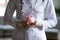 Close up young female doctor holding pink piggy bank