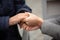 Close-up of young female hands holding senior woman hands