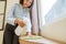 close up of young female housemaid spraying and wiping table