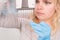 Close up of Young female scientist working in genetics laboratory with pipette in white biological sample