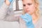 Close up of Young female scientist working in genetics laboratory with pipette in white biological sample