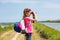 Close up of a young girl looking through binoculars at birds