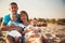 Close up of young happy loving family with small kids in the middle, having fun at beach together near the ocean, happy lifestyle