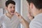 Close up of young latin man removing orthodontic silicone trainer.