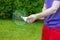 Close up young male badminton player holds racket with shuttle outdoors