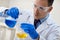 close up of young male scientist with flask making test or research.