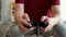 Close up of young man holding game controller while playing video console game. Asian guy using gamepad joystick at home