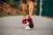 A close-up of a young man jogging in trainers, rear view