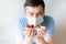 Close up Young Man in medical mask holding bowl with strawberry. man in an anti-virus medical mask . recovery from