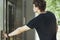 Close up of young man pressing the button of elevator at metro station.