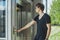 Close up of young man pressing the button of elevator at metro station.