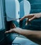 Close up. young man pushing a dispenser with bactericidal soap.