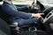 Close up of young man in suit driving car