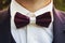 Close-up of a young man wearing a tuxedo with a bow tie. A male suit with a handsome bow tie for formal festive wear. Groom\'s sui