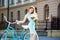 Close-up young model posing with peonies near vintage bicycle