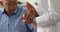 Close up young nurse holding hand of old male patient.