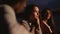 Close up of young people on the beach at night