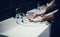 Close up. young people wash their hands in a public restroom