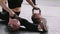 Close-up young professional athletic woman doing split stretch exercise on kettlebells on gym floor slow motion.