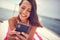 Close-up of a young sexy girl who is lying on the towel and chatting on a smartphone while enjoying a sunbath. Summer, sea,