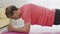 Close up of young transgender homosexual man with make up doing static plank on mat