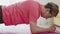 Close up of young transgender homosexual man with make up doing static plank on mat