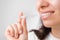 Close up of a young woman adjusting transparent aligners. Taking care of teeth. Orthodontic treatment for straightening