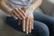 Close up young woman applying moisturizing balm on hands.