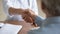 Close up young woman doctor shaking mature patient hand