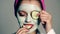 Close up young woman with a facial cream on her face. Funny girl, skin care. Model with a face mask and a towel on her