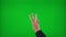 Close up of young woman hands counting backward from five to one on green screen background -