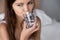 Close up young woman holding glass drinking water