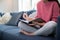 Close Up Of Young Woman Relaxing On Sofa At Home Writing In Journal