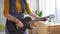 Close up of young woman rocker playing electric guitar in modern apartment