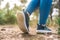 close-up of a young woman's blue sports shoes. woman athlete playing sport outdoors. concept of wellbeing and