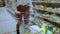 Close-up of a young woman's hands moving a grocery cart through the aisles of a supermarket, the concept of sale and