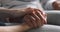 Close up young woman stroking hand of middle aged mother.