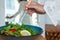 Close-up Young Woman Tossing Salad At Lunch