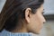 Close Up Of Young Woman Wearing Behind The Ear Hearing Device Or Aid