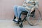 Close up of a young woman in a wheelchair while walking in a park on a sunny day. Recovery and healthcare concepts