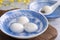 Close up of yuanxiao tangyuan in a bowl on gray table, food for Chinese Lantern Yuanxiao Festival