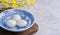 Close up of yuanxiao tangyuan in a bowl on gray table, food for Chinese Lantern Yuanxiao Festival