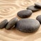 Close up of zen garden with group of black stones