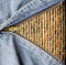 Close up of zipper with grunge wall in blue denim.