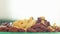 Close up zoom in view plate with tasty colorful cereals in green plate with blank space bright white background