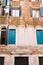 Close-ups of building facades in Venice, Italy. The facade of a five-storey building with classic Venetian arched