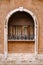 Close-ups of building facades in Venice, Italy. A stone arch above a wooden window on the facade of building. White