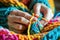 Close-ups of hands knitting or crocheting with vibrant yarn