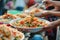 Close-ups of multicultural people enjoying local delicacies on exotic market in the vibrant atmosphere