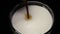 Close-ups on the top of the coffee jet, which is poured into a glass of mocha or latte